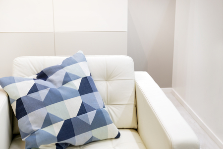 Interior of the living room with white sofa with colorful pillows and a blanket.の写真素材