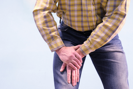Muscle pain in the thigh. The man grabbed his thigh in a fit of pain. Suffers from diseases of...