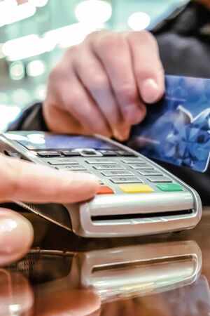 Payment by card, in the payment terminal. Electronic money. Mobile banking. Shopping complexの写真素材