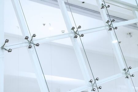 Fastener for glass, glass facade. Business centre. Industrial background