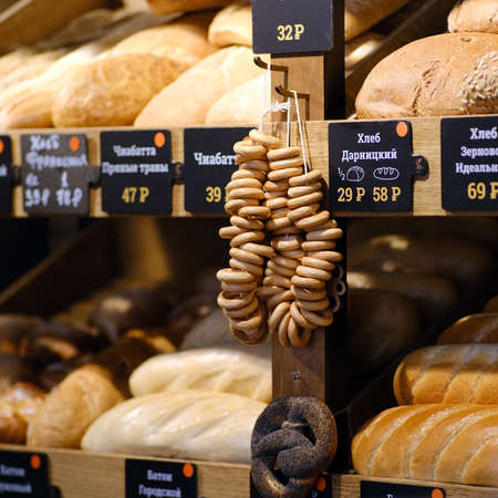 Fresh bread on the store shelves. Wheat white rolls, rye black bread 03.29.2020のeditorial素材