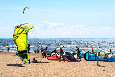 Kitesurfing is an extreme sport. The competitions of kite surfers. Bright colored paragliders on the...