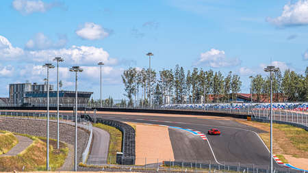 Ring road of the sports complex Igora Drive A section of road, a red sports car on the turn. Saint-Petersburg. Russia. July 4, 2020のeditorial素材