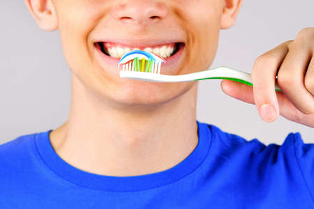 Toothpaste toothbrush on the background of a smiling face. Isolated background. Health.の写真素材