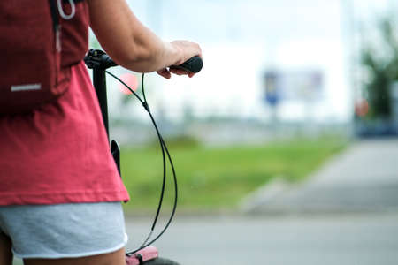 The girl holds the handlebar of the bike in a beautiful style. Active lifestyleの写真素材
