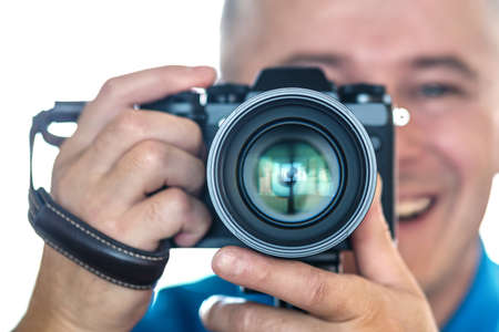 Blur the background. Selective focus. The photographer holds the camera. Smiling takes a pictureの写真素材