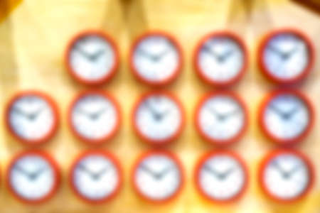 Blur the background. The clock on the wall is arranged in a row.の写真素材