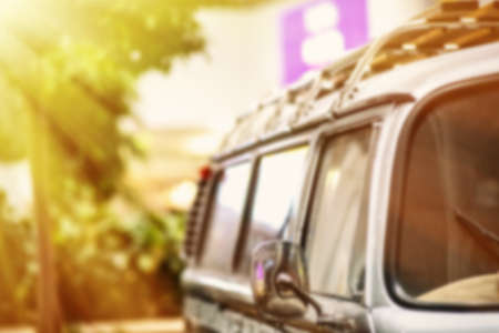Blur the background. The car is parked in the shade of a tree. Selective focus. Filter.の写真素材