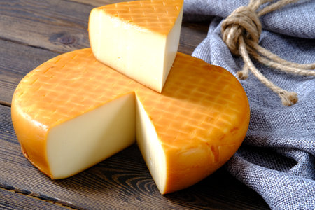 italian toma hard cheese seasoning in a cold and dark cellarの写真素材