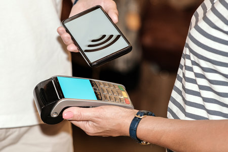 Payment by smartphone in the payment terminal. Electronic money. Mobile banking. Shopping complex.の写真素材