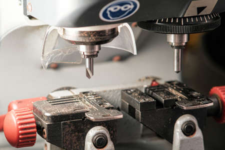 A copy machine for making keys. A milling cutter for cutting a duplicate. The locksmiths theme. Key blanks for cutting.の写真素材