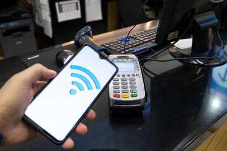 Payment by card, in the payment terminal. Electronic money. Mobile banking. Shopping complex.の写真素材