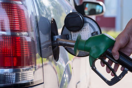 Gas station pistol in the drivers hand. Modern gas station pump, excellent design for any purpose....