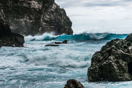 Big waves breaking and splashing on the rocks