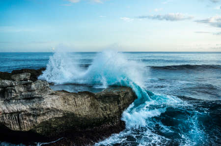 Big waves breaking and splashing on the rocks. Devil's Tear. Nusa Lembongan, Indonesia