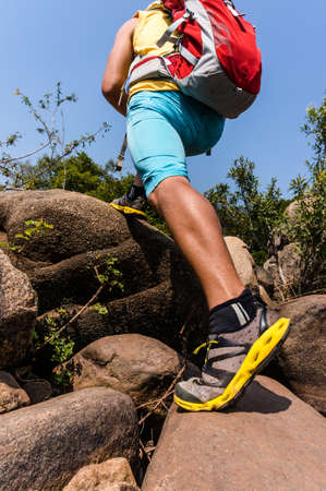 Traveler going uphill on the rocks