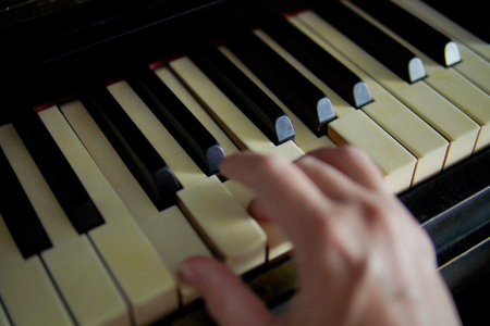 hand playing antique piano keysの写真素材