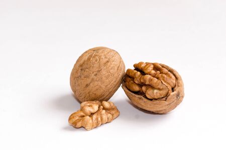 Delicious whole and broken walnuts, isolated on white backgroundの写真素材
