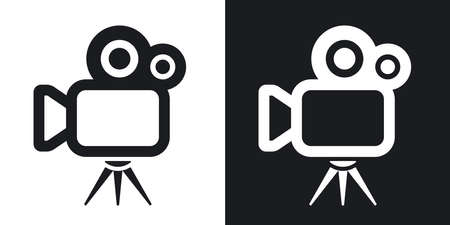 Vector movie camera icon. Two-tone version on black and white backgroundのイラスト素材