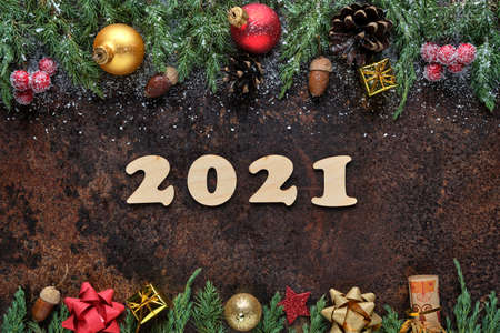 New Years Eve festive background with wooden numbers 2021 and Christmas decorations on stone surface. Flat lay, view from aboveの写真素材