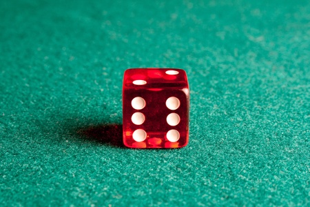 close up of red dice on green table