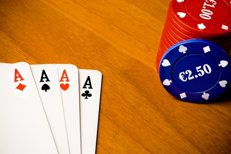 detail of poker and gambling chips on old wood