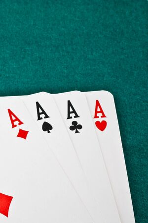 winning poker hand in corner in of a green fabric background の写真素材