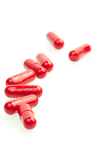 close-up of red medical pills on white backgroundの写真素材