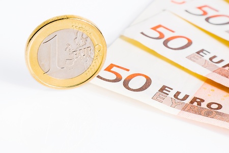detail of one euro coin on 50-euro banknotes on white backgroundの写真素材