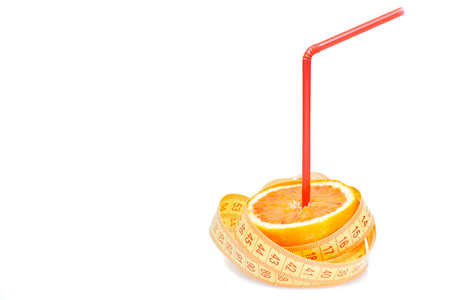 an half orange with tape measure and straw, with space for text on white backgroundの写真素材