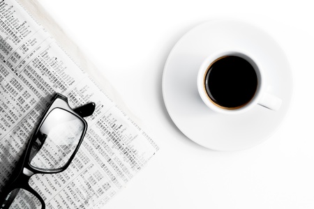 top of view of coffee near financial newspaper and glasses