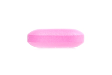 one pink medical pill isolated on white backgroundの写真素材