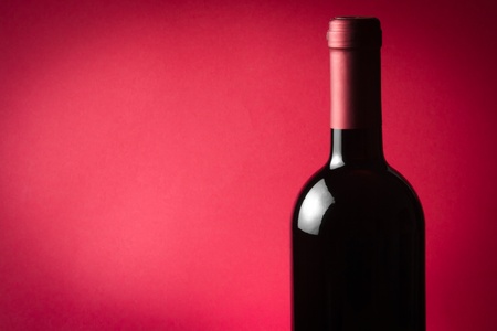 bottle of wine on red backgroundの写真素材