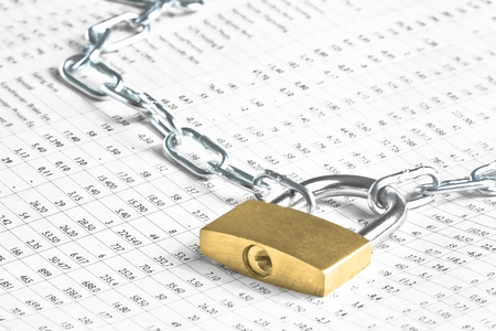lock security with chain on financial newspaper. Money for safety and investment.の写真素材