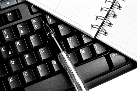 top of view of a notebook, keyboard and penの写真素材
