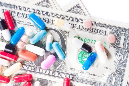 top of view of colorful pills on american dollar on laboratory table