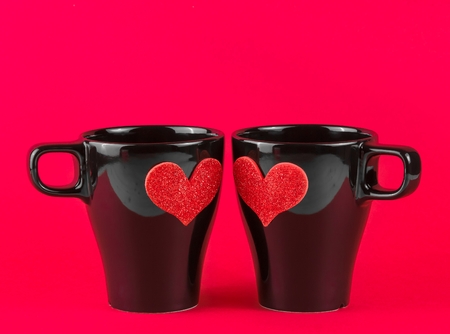 valentine day series, cups of milk with decorative heart on red background with space for textの写真素材