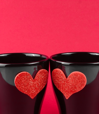 valentine day series, detail of cups of milk with decorative heart on red background with space for textの写真素材