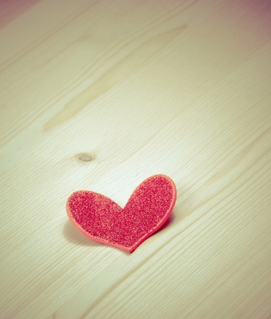 vintage style of decorative red heart on wood background with space for text, concept of valentine dayの写真素材