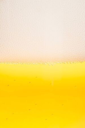 detail of fresh beer with bubbles and foam for background