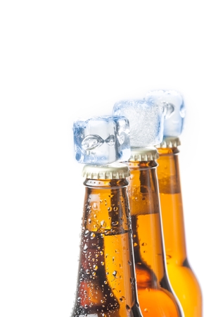 three bottle of fresh beer with ice on top and drops,concept of fresh beer on summer, on white backgroundの写真素材