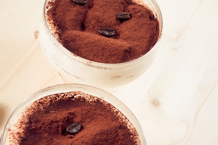 close-up of italian tiramisu dessert served in a cup with coffee beansの写真素材
