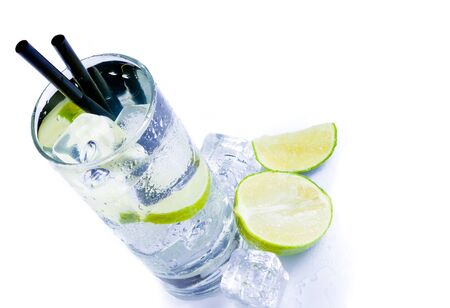top of view of cocktail glass with ice and lime slice isolated on white backgroundの写真素材