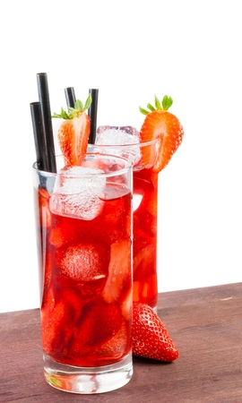 glasses of strawberry cocktail with ice on old wood table and a white backgroundの写真素材