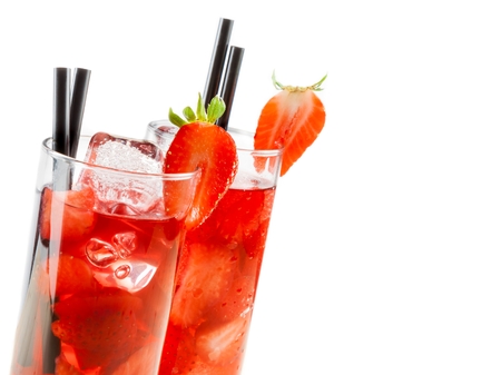 glasses of strawberry cocktail with ice isolated on white background with strawberry on top and space for textの写真素材