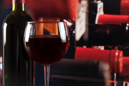 wine glass near bottle in the wine cellar with space for textの写真素材