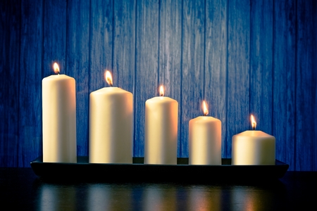 white candles on wood table and old wooden backgroundの写真素材