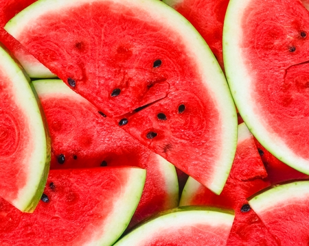Abstract background with slices of fresh ripe red watermelonsの写真素材