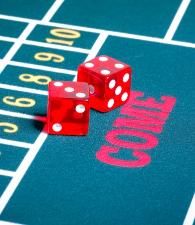 Two red dice on green gambling game gamble concept