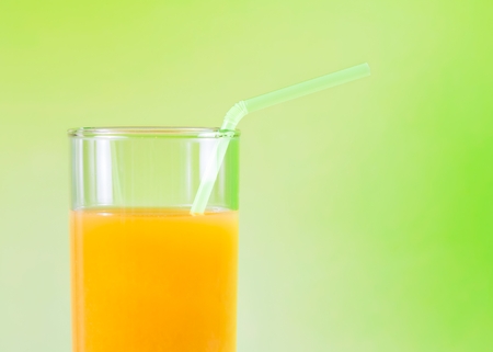 Orange juice on the wood table on green backgroundの写真素材